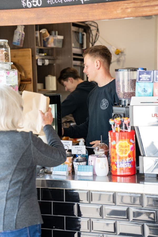 Branded uniforms behind a Canberra cafe counter